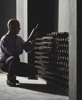 man inspecting bottle of wine